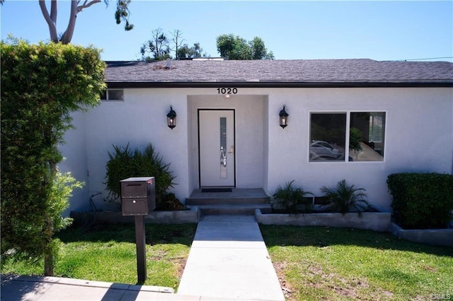 1020 Lantana Dr, Los Angeles, CA 90042 - view of exterior entry featuring stucco siding and a yard