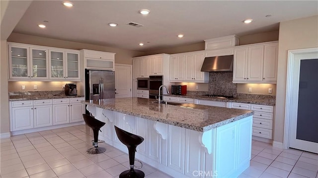 1167 Tesoro Pl, Vista, CA 92081 - kitchen with range hood, stainless steel fridge with ice dispenser, white cabinetry, a breakfast bar, and recessed lighting