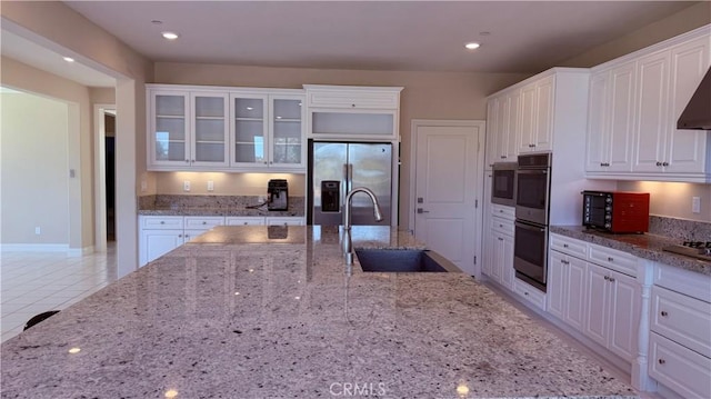 1167 Tesoro Pl, Vista, CA 92081 - kitchen featuring appliances with stainless steel finishes, white cabinetry, glass insert cabinets, light tile patterned flooring, and recessed lighting