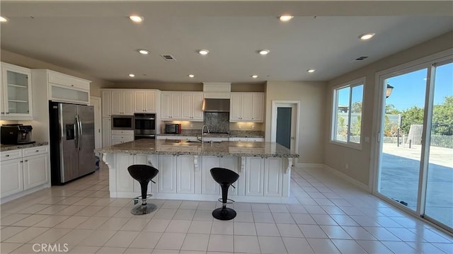 1167 Tesoro Pl, Vista, CA 92081 - kitchen featuring appliances with stainless steel finishes, tasteful backsplash, ventilation hood, light stone counters, and recessed lighting