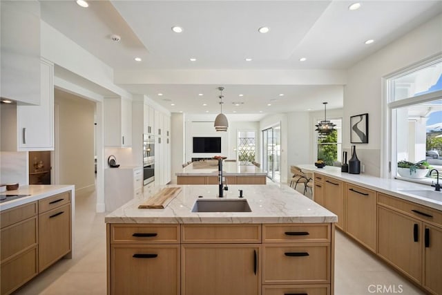 4 Ebony Glade, Laguna Niguel, CA 92677 - kitchen featuring open floor plan, an island with sink, recessed lighting, light stone counters, and pendant lighting