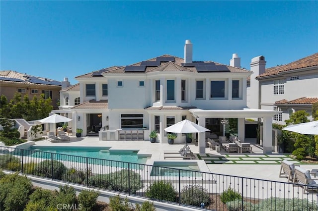 4 Ebony Glade, Laguna Niguel, CA 92677 - rear view of house with a fenced backyard, a patio area, an outdoor hangout area, and solar panels