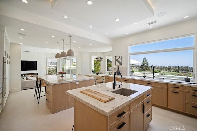 4 Ebony Glade, Laguna Niguel, CA 92677 - kitchen featuring a large island, recessed lighting, open floor plan, light stone counters, and a breakfast bar area