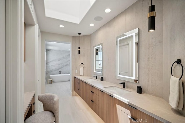 4 Ebony Glade, Laguna Niguel, CA 92677 - bathroom featuring double vanity, a freestanding bath, recessed lighting, and a skylight