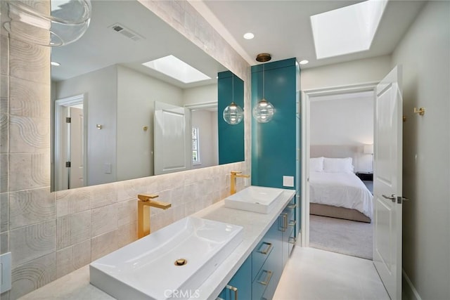 4 Ebony Glade, Laguna Niguel, CA 92677 - bathroom featuring a skylight, double vanity, ensuite bathroom, decorative backsplash, and recessed lighting
