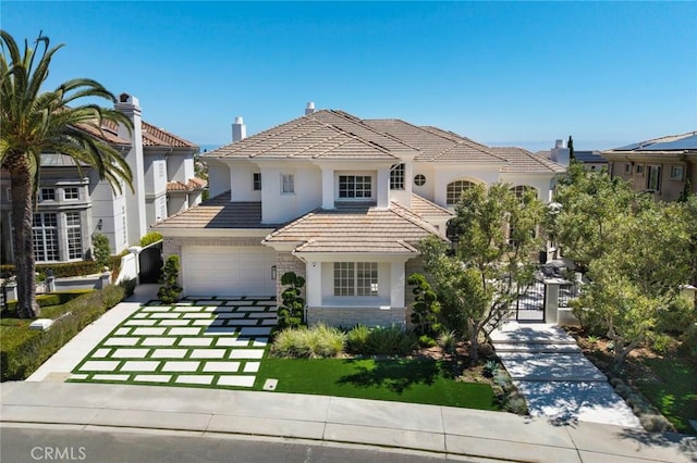 4 Ebony Glade, Laguna Niguel, CA 92677 - view of front of property featuring a gate, stucco siding, a tile roof, an attached garage, and stone siding