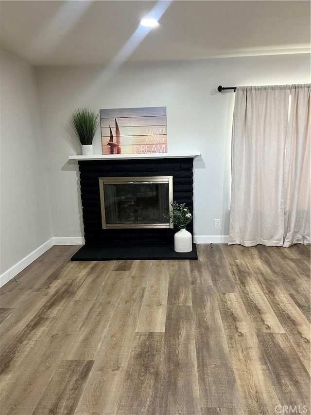 1135 W Coolfield Dr, Covina, CA 91722 - detailed view of a glass covered fireplace and wood finished floors