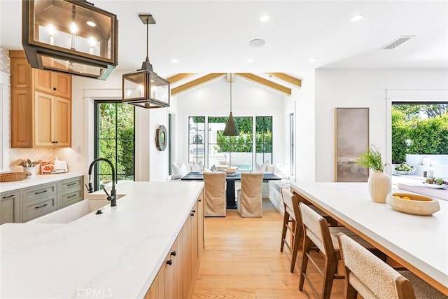 2001 Port Ramsgate Pl, Newport Beach, CA 92660 - kitchen with light wood-style floors, recessed lighting, vaulted ceiling, hanging light fixtures, and decorative backsplash