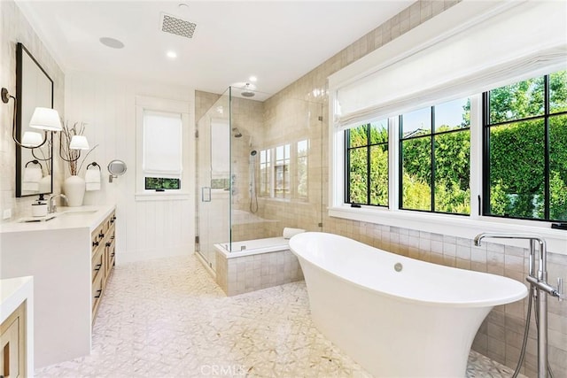 2001 Port Ramsgate Pl, Newport Beach, CA 92660 - full bathroom featuring double vanity, a shower stall, a freestanding tub, and tile walls