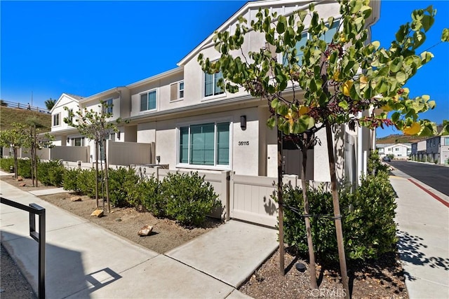 35115 Vine Pl, Fallbrook, CA 92028 - townhome / multi-family property with a fenced front yard and stucco siding