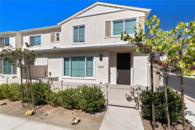 35115 Vine Pl, Fallbrook, CA 92028 - view of property with a fenced front yard, stucco siding, a gate, and board and batten siding