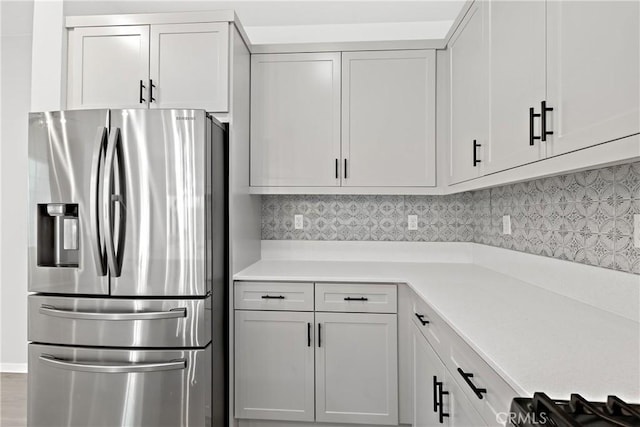 35115 Vine Pl, Fallbrook, CA 92028 - kitchen featuring stainless steel refrigerator with ice dispenser, light countertops, decorative backsplash, and white cabinetry