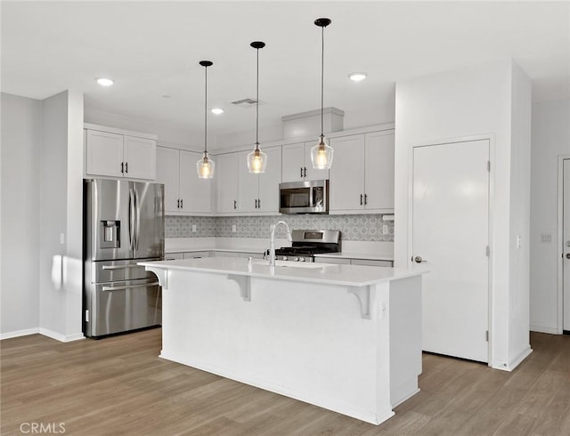 35115 Vine Pl, Fallbrook, CA 92028 - kitchen featuring stainless steel appliances, light countertops, a breakfast bar area, tasteful backsplash, and recessed lighting