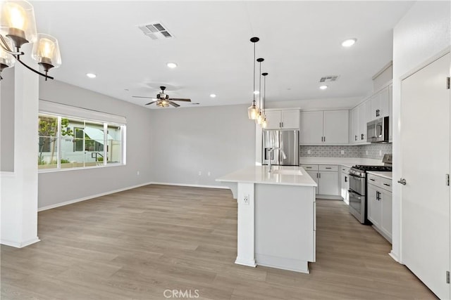 35115 Vine Pl, Fallbrook, CA 92028 - kitchen featuring appliances with stainless steel finishes, a ceiling fan, decorative backsplash, light countertops, and recessed lighting