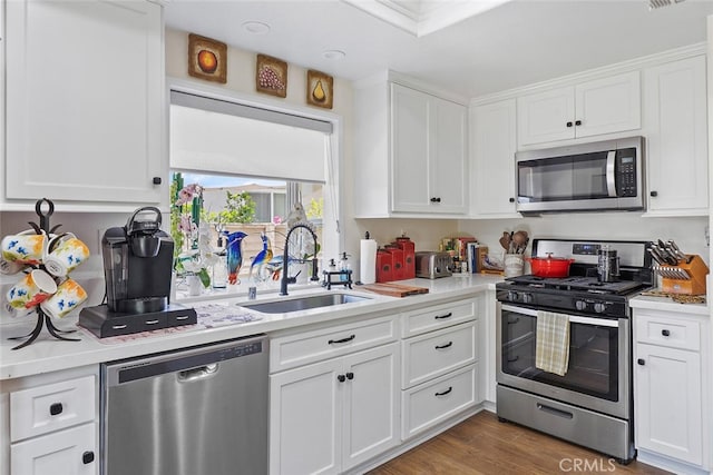 10 Glenhurst Unit 37, Irvine, CA 92604 - kitchen featuring appliances with stainless steel finishes, light countertops, and white cabinetry