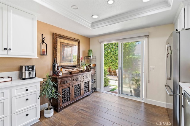 10 Glenhurst Unit 37, Irvine, CA 92604 - doorway featuring a tray ceiling, crown molding, wood finished floors, and recessed lighting