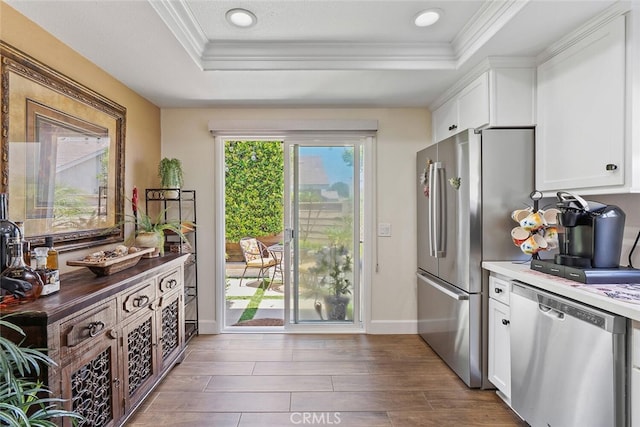 10 Glenhurst Unit 37, Irvine, CA 92604 - kitchen with stainless steel appliances, a tray ceiling, ornamental molding, white cabinets, and recessed lighting