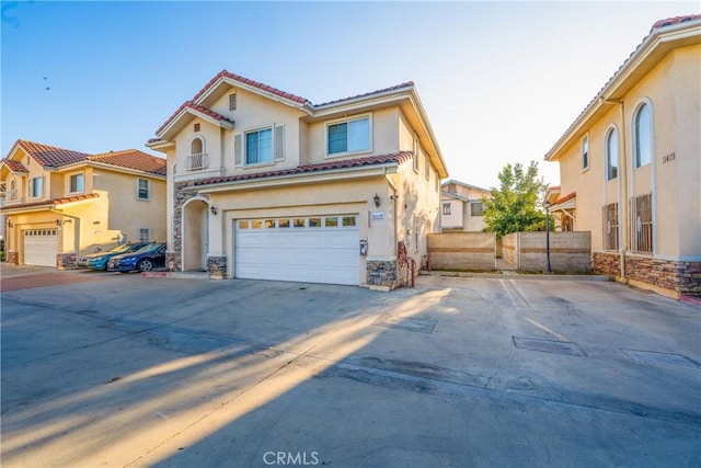 11411 Elliott Ave, El Monte, CA 91732 - mediterranean / spanish-style house featuring stucco siding, a tile roof, a garage, concrete driveway, and stone siding