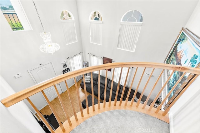 11411 Elliott Ave, El Monte, CA 91732 - stairs featuring a towering ceiling, a chandelier, and wood finished floors