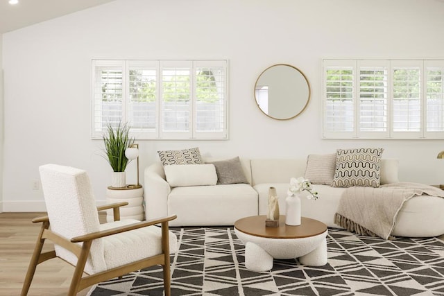 4380 Rolfe Rd, San Diego, CA 92117 - living room featuring plenty of natural light, wood finished floors, and vaulted ceiling