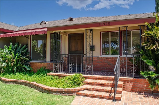 10520 Haskell Ave, Granada Hills, CA 91344 - view of exterior entry featuring a porch, brick siding, and stucco siding