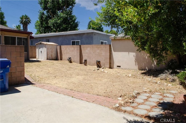 10520 Haskell Ave, Granada Hills, CA 91344 - view of side of property featuring a shed, a patio area, and stucco siding