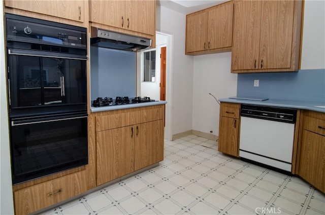 10520 Haskell Ave, Granada Hills, CA 91344 - kitchen featuring black appliances, under cabinet range hood, light floors, and light countertops