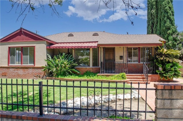 10520 Haskell Ave, Granada Hills, CA 91344 - view of front of property featuring brick siding, a porch, a fenced front yard, and a shingled roof