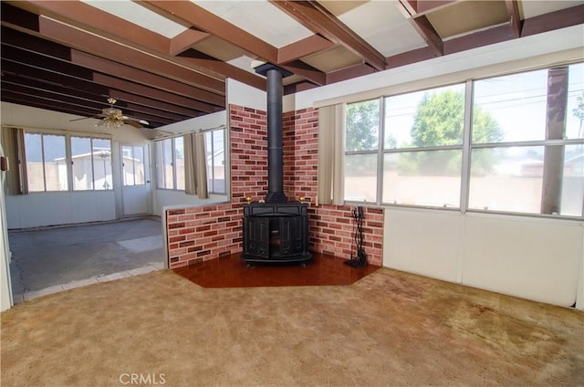 10520 Haskell Ave, Granada Hills, CA 91344 - unfurnished sunroom with a wood stove, plenty of natural light, and beam ceiling