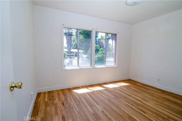 10520 Haskell Ave, Granada Hills, CA 91344 - empty room with baseboards and light wood finished floors