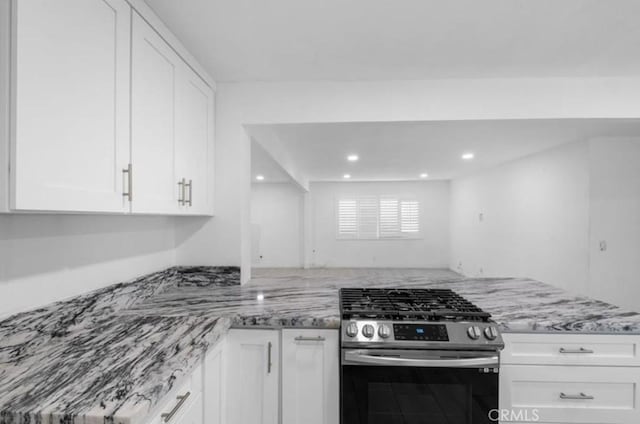 7915 Helena Ave, Riverside, CA 92504 - kitchen featuring stainless steel gas range oven, white cabinetry, light stone counters, recessed lighting, and a peninsula