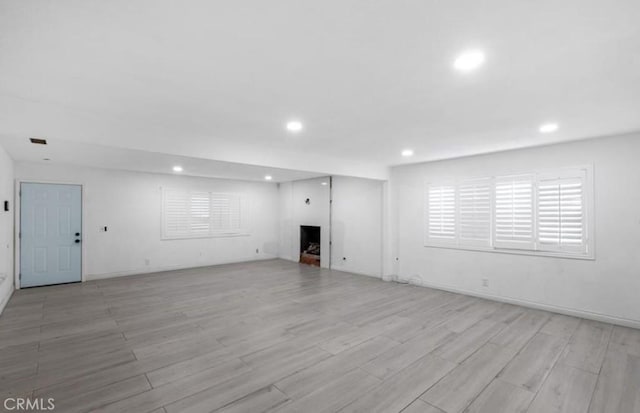 7915 Helena Ave, Riverside, CA 92504 - unfurnished living room with recessed lighting, light wood finished floors, and a fireplace