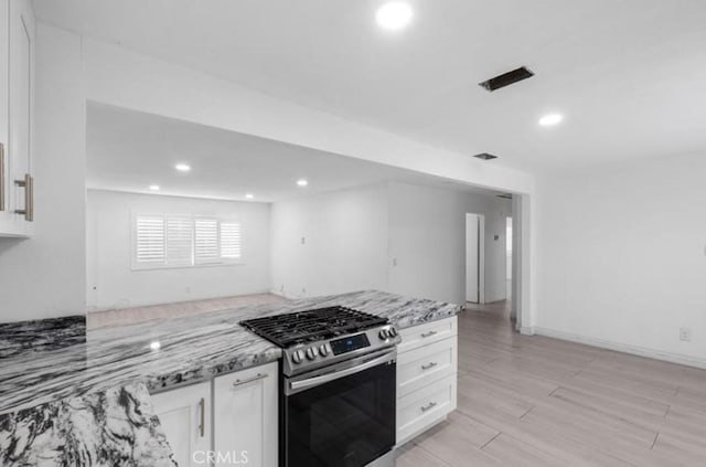 7915 Helena Ave, Riverside, CA 92504 - kitchen featuring stainless steel gas range, white cabinetry, light stone countertops, recessed lighting, and light wood-style flooring