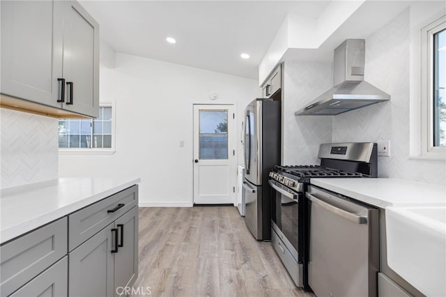 853 N Jasmine Ave, Ontario, CA 91762 - kitchen with wall chimney range hood, stainless steel appliances, decorative backsplash, light wood-style flooring, and recessed lighting