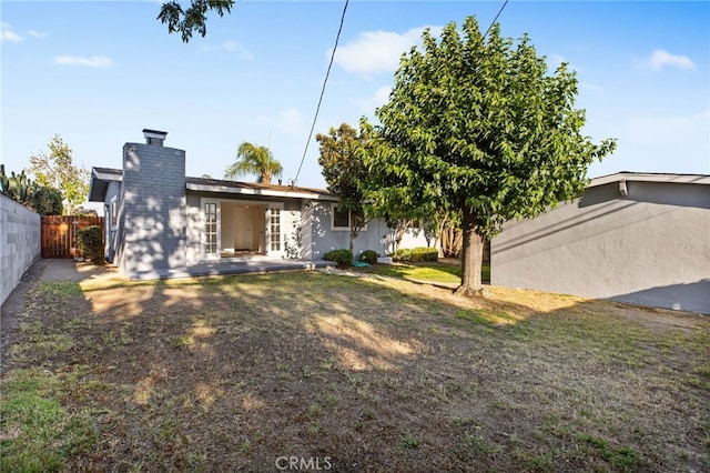 853 N Jasmine Ave, Ontario, CA 91762 - back of property featuring a chimney and a patio area