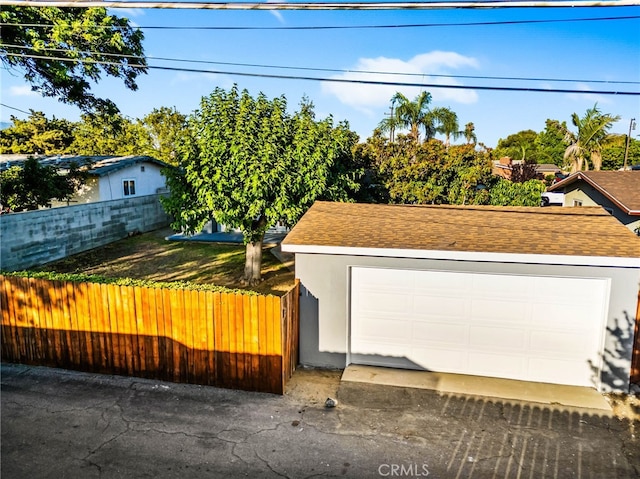 853 N Jasmine Ave, Ontario, CA 91762 - view of front of home with stucco siding, a detached garage, roof with shingles, and an outbuilding