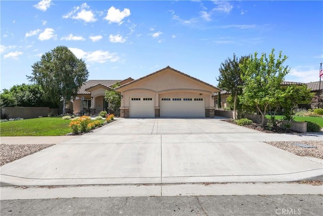 1018 W 15th St, Upland, CA 91786 - view of front of property with a garage, stucco siding, driveway, and stone siding