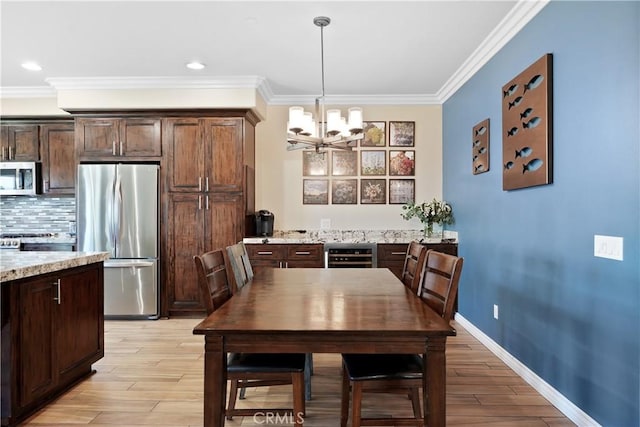 1018 W 15th St, Upland, CA 91786 - dining area with a chandelier, wine cooler, light wood-type flooring, ornamental molding, and recessed lighting