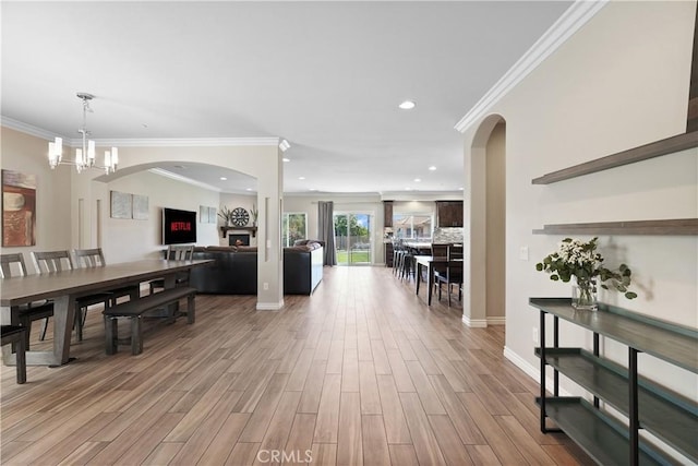1018 W 15th St, Upland, CA 91786 - dining area featuring ornamental molding, light wood-style floors, arched walkways, a chandelier, and recessed lighting