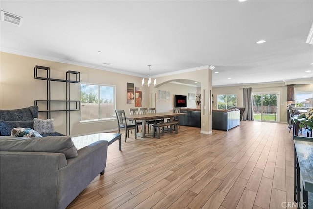 1018 W 15th St, Upland, CA 91786 - living room featuring a chandelier, light wood finished floors, recessed lighting, crown molding, and arched walkways