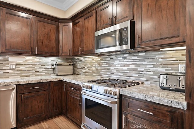 1018 W 15th St, Upland, CA 91786 - kitchen featuring appliances with stainless steel finishes, tasteful backsplash, light stone countertops, and dark brown cabinets