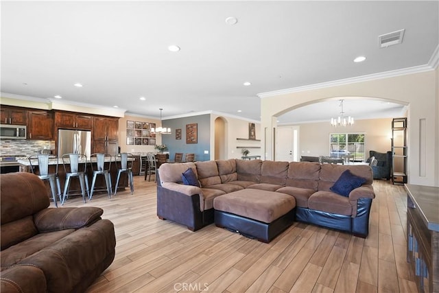 1018 W 15th St, Upland, CA 91786 - living area featuring a chandelier, arched walkways, light wood-style floors, recessed lighting, and ornamental molding