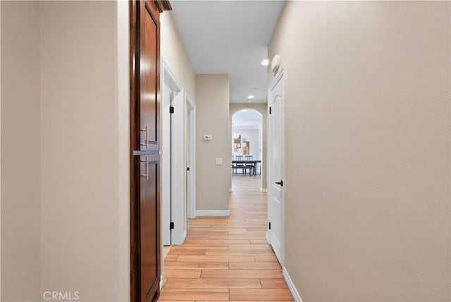 1018 W 15th St, Upland, CA 91786 - hallway featuring light wood-style flooring, arched walkways, and recessed lighting