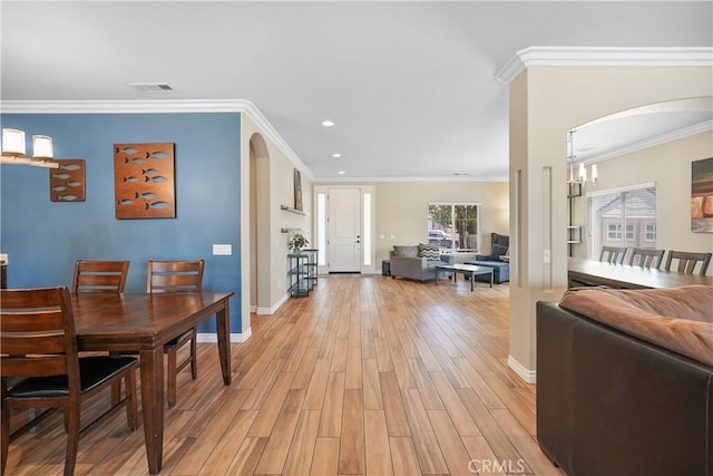 1018 W 15th St, Upland, CA 91786 - dining area with arched walkways, light wood-style floors, recessed lighting, and ornamental molding