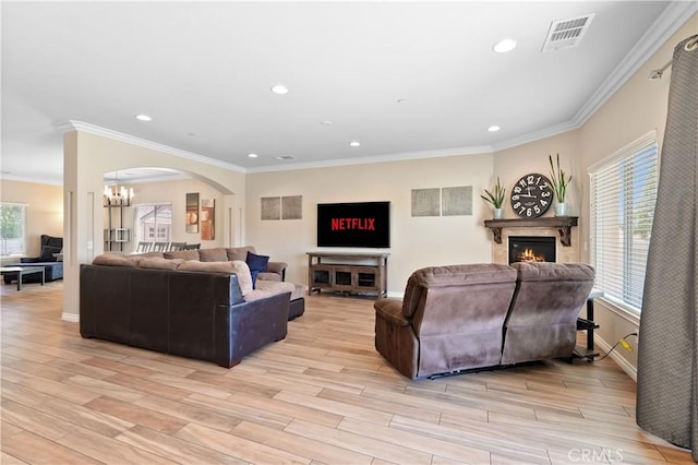 1018 W 15th St, Upland, CA 91786 - living room with a lit fireplace, crown molding, light wood-type flooring, recessed lighting, and a chandelier