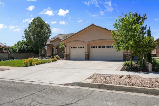 1018 W 15th St, Upland, CA 91786 - view of front of house featuring an attached garage, stucco siding, stone siding, and concrete driveway