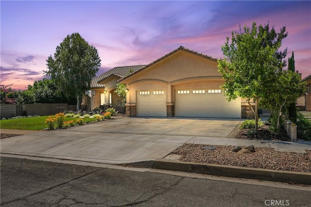 1018 W 15th St, Upland, CA 91786 - view of front of property with an attached garage, concrete driveway, stucco siding, and stone siding