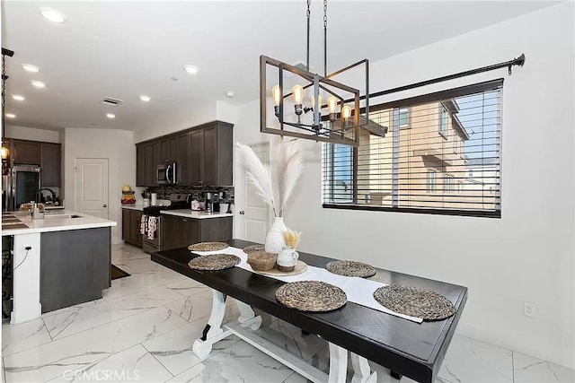 12465 Gramercy Ln, Victorville, CA 92392 - dining area featuring healthy amount of natural light, a chandelier, light marble finish flooring, and recessed lighting