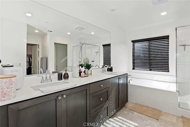 12465 Gramercy Ln, Victorville, CA 92392 - bathroom featuring a shower stall, double vanity, a garden tub, recessed lighting, and a walk in closet
