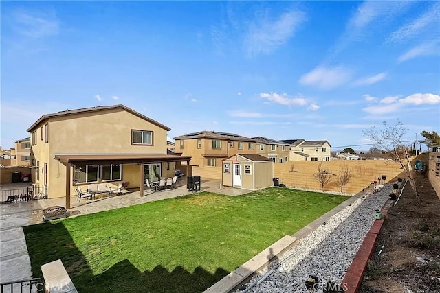 12465 Gramercy Ln, Victorville, CA 92392 - back of house featuring a storage unit, a fenced backyard, a patio area, and a residential view